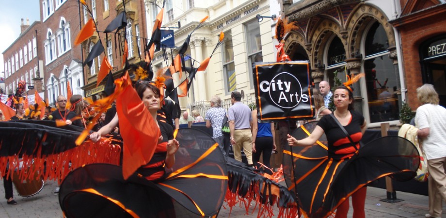 City Arts Carnival Troupe in orange costumes
