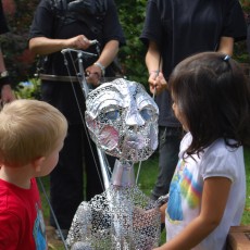Two children look at the Star Child puppet