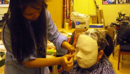 Girl moulds mask to a face