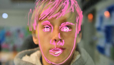 Child's face painted on window