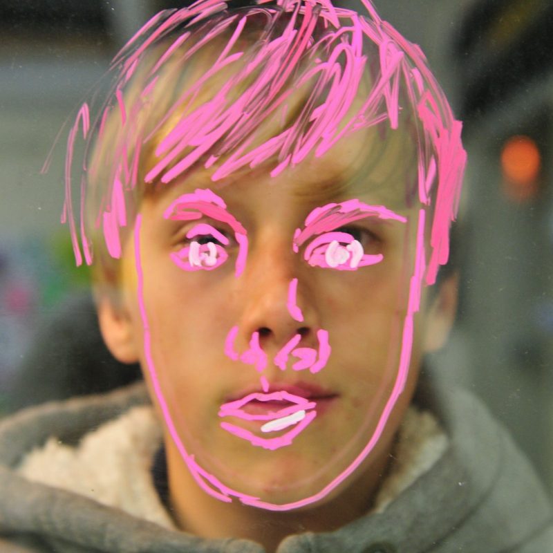 Child's face painted on window