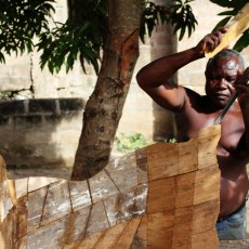 Man carving a coffin