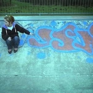 Girl sat with graffiti