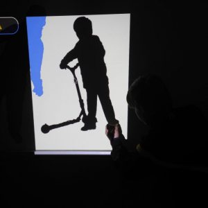 Silhouette of child being painted on wall