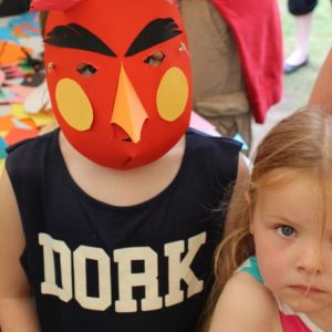Child wearing paper bird mask