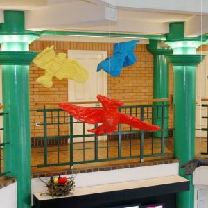 Painted model birds suspended in Gedling Civic Centre Atrium
