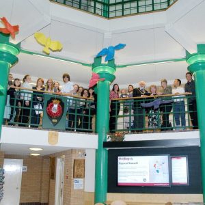 Audience enjoy painted model birds suspended in Gedling Civic Centre Atrium
