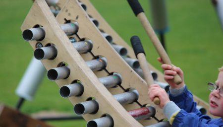 Child plays chime instrument.