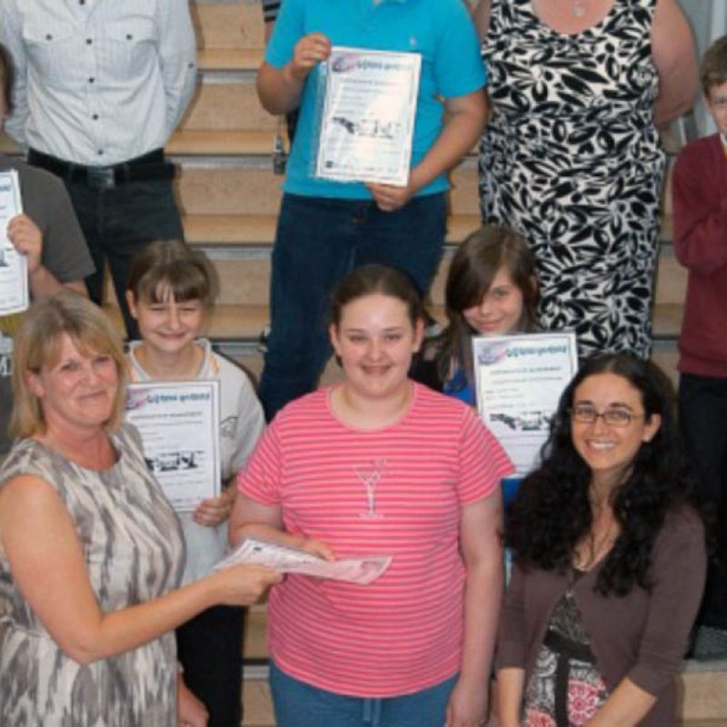 Young people holding certificates