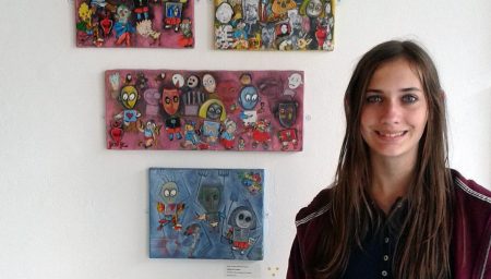 Teenger standing with artwork