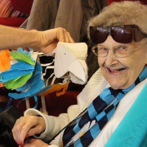 Older people play with bird puppet