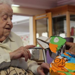 Older people play with bird puppet