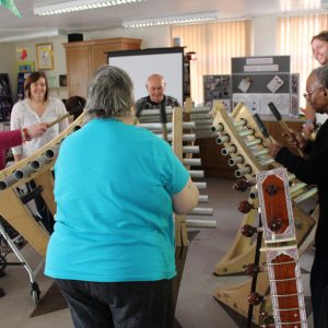 Older people play giant chimes