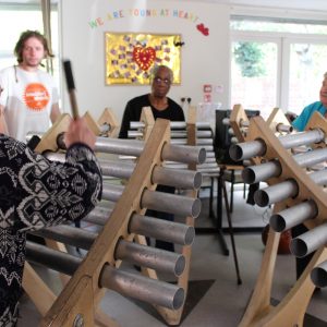 Older people play giant chimes