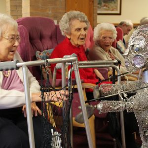 Older people meet alien puppet
