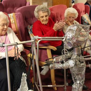 Older people meet alien puppet