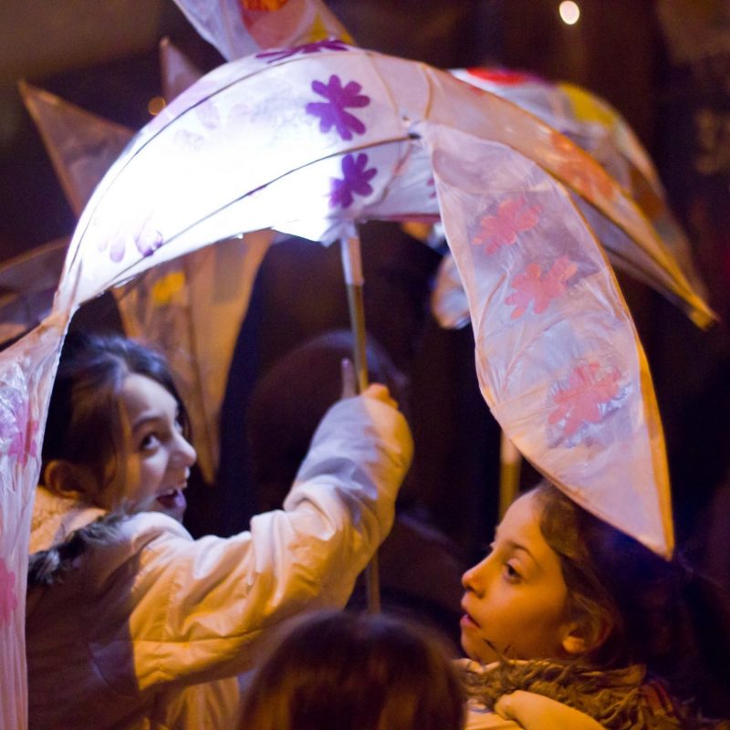 Children carry lanterns