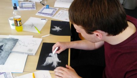 Young person drawing with chalk