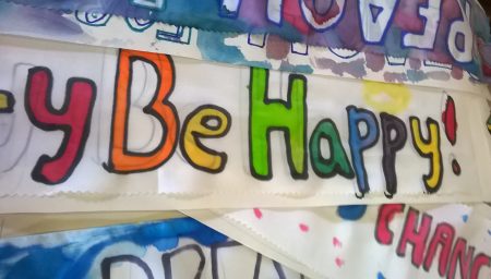 Silk with 'Be Happy' painted on it