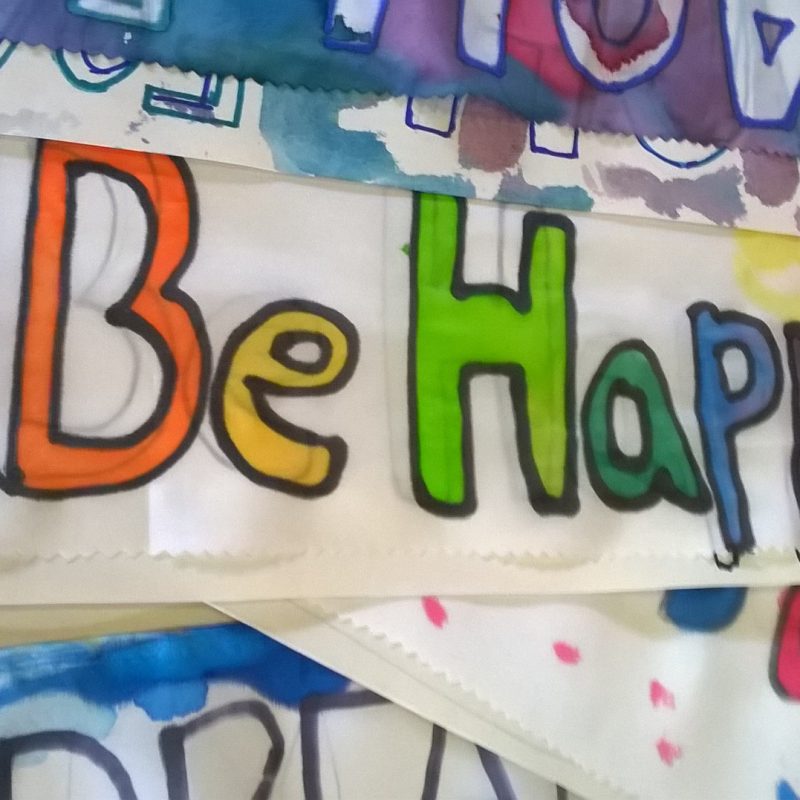 Silk with 'Be Happy' painted on it
