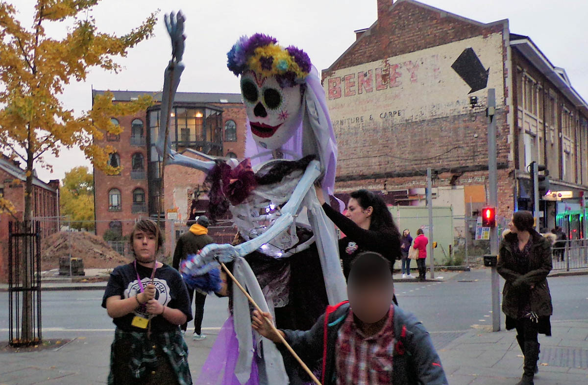 Young people and giant 'Day of the Dead' puppet