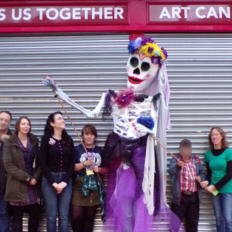 Young people and giant 'Day of the Dead' puppet