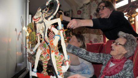 Older people operate puppets