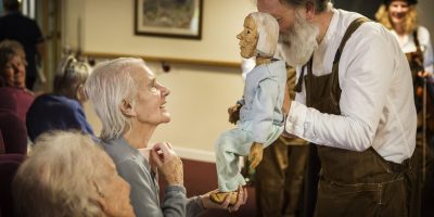 Care home resident at puppet show performance