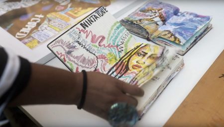 Artist Honey Williams leafing through sketchbook