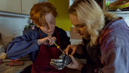 Cawley and Meridith tighten screw on homemade metal forearm armour