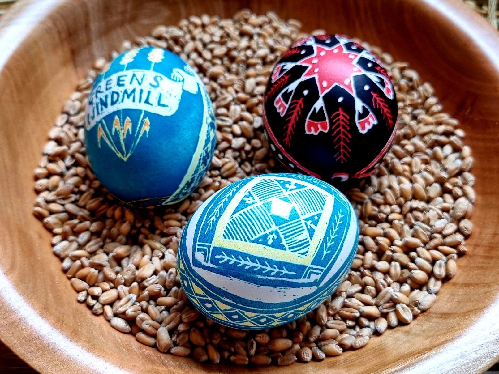 Three Pysanky Eggs in a Wooden Bowl