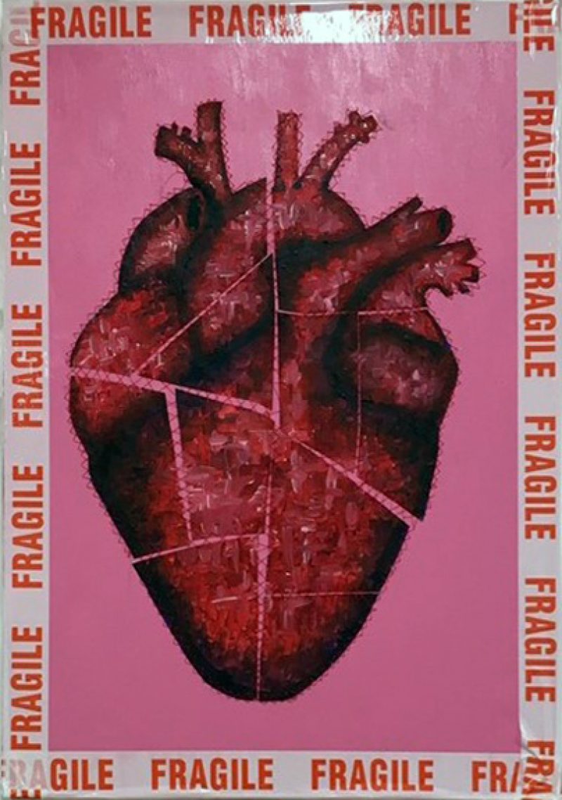 At the center there is collage of a heart organ, cut up and stuck together by read thread that looks like stitching. It is set against a bright pink background, and the border is framed in ‘FRAGILE’ tape.