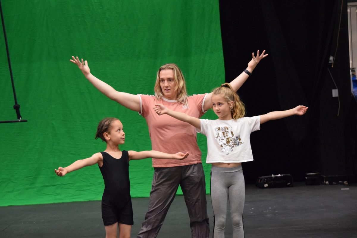 Sophie Duncan and two children rehearse a dance