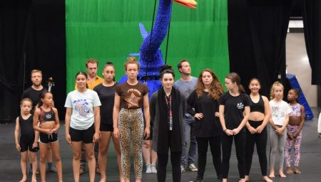 Musical cast in rehersals with a giant puppet