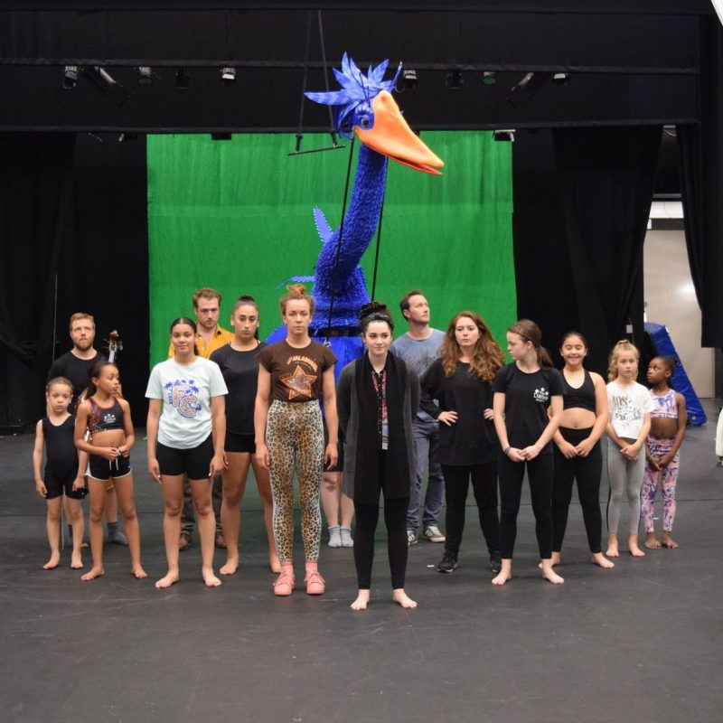Musical cast in rehersals with a giant puppet