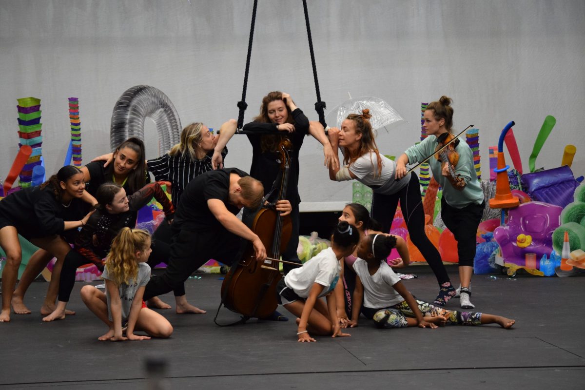 Team of mixed age performers in rehersals with a trapeze