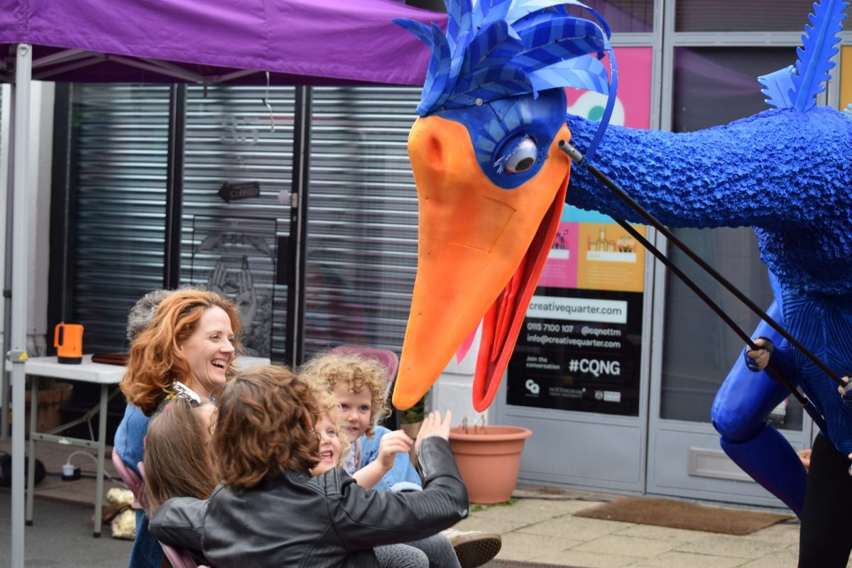 Giant bird-like puppet appears to bit child's hand