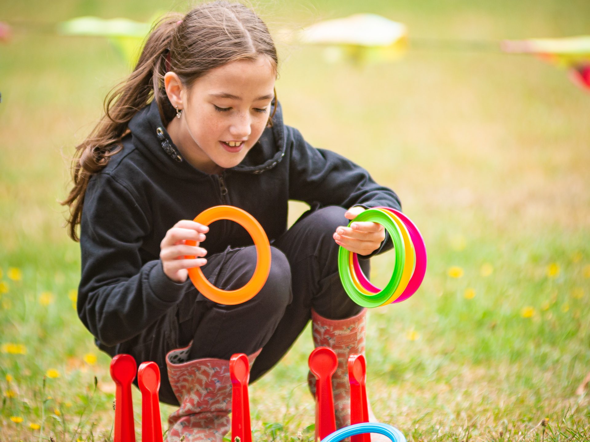 Young girl plays with plastic ring toys