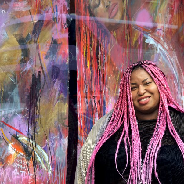 Artist Honey Williams stands in front of her work