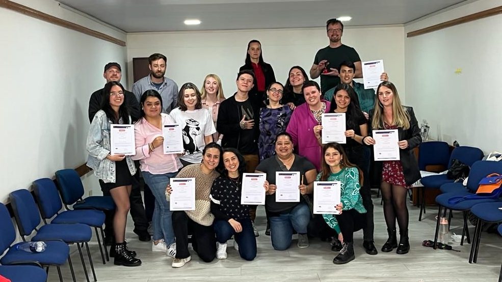 Group of people holding certificates