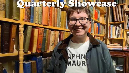 Promotional poster for the DIY Poets Quarterly Showcase featuring Jade Moore. The poster shows a smiling person with short hair and glasses standing in front of shelves filled with colorful books. They are wearing a shirt with text partially visible under a jacket. The DIY Poets logo is in the top left corner, and the event title 'DIY Poets Quarterly Showcase Featuring Jade Moore' is displayed in large white letters.