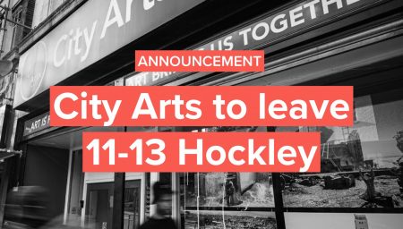 Black-and-white photo of the City Arts building at 11-13 Hockley. The storefront signage reads ‘City Arts’, with posters visible in the window. Two blurred figures walk past, creating a sense of movement. Overlaid red banners read ‘Announcement’ and ‘City Arts to leave 11-13 Hockley’, with the City Arts logo at the bottom.