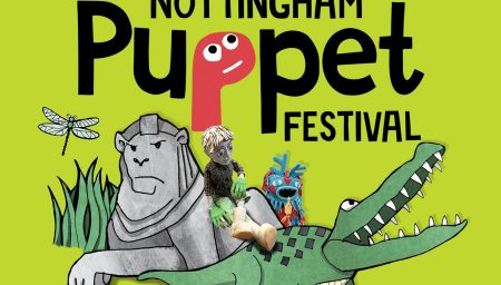 Bright green promotional graphic with the text ‘NOTTINGHAM Puppet FESTIVAL’. The word ‘Puppet’ features a pink puppet-shaped letter ‘P’ with cartoon eyes. Illustrated characters include a grey stone lion, a green crocodile with sharp teeth, a dragonfly, grass, and two colourful puppets sitting on the crocodile’s back, including a handmade figure with large eyes, green gloves and white boots.